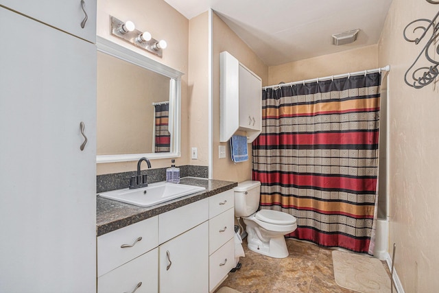 bathroom featuring toilet and vanity