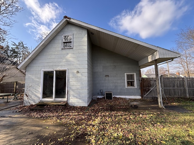 back of house with central air condition unit