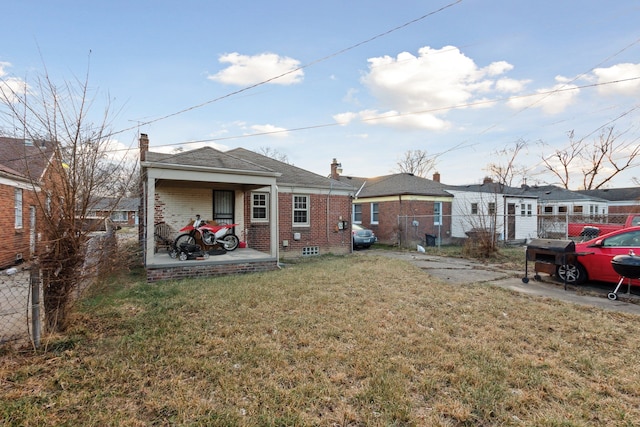 rear view of property with a yard