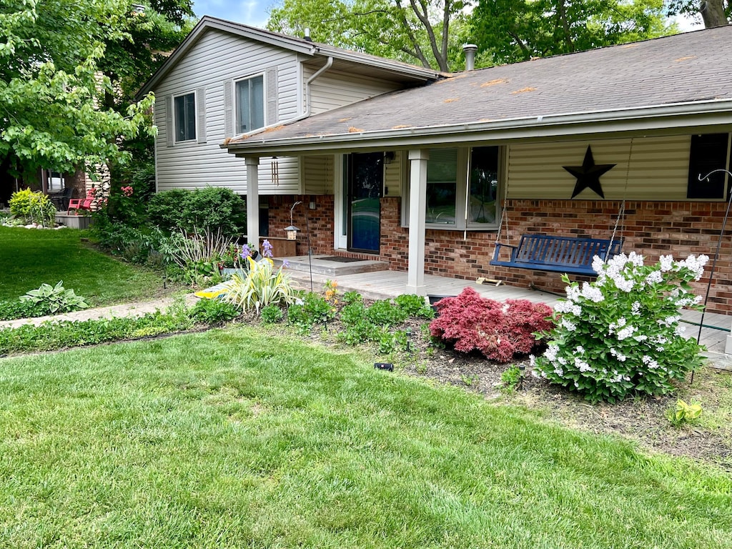 exterior space with a porch and a lawn