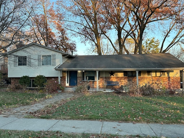 split level home featuring a porch and a front yard