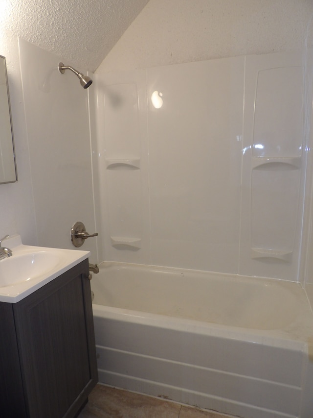 bathroom with shower / bathtub combination, a textured ceiling, and vanity