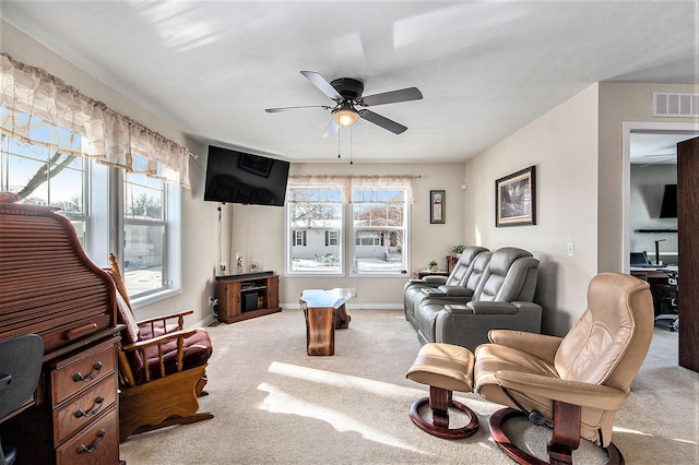 living room featuring ceiling fan, light colored carpet, and plenty of natural light