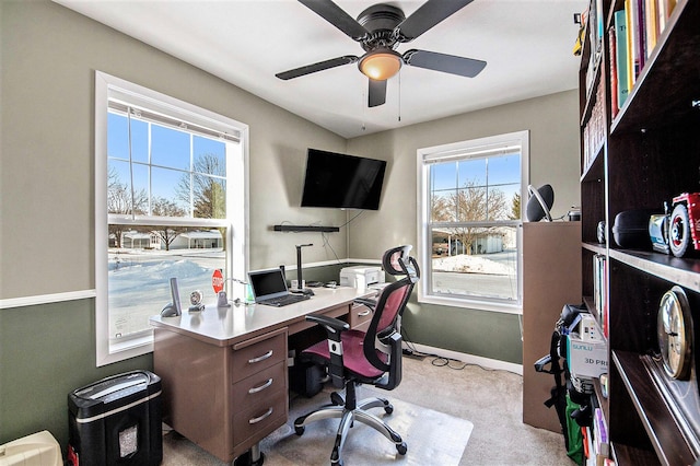 home office featuring ceiling fan and light carpet