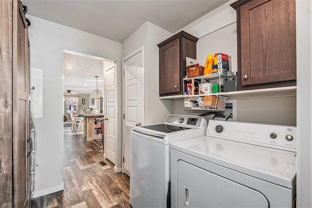 clothes washing area with washer and dryer, cabinets, dark hardwood / wood-style flooring, and ceiling fan