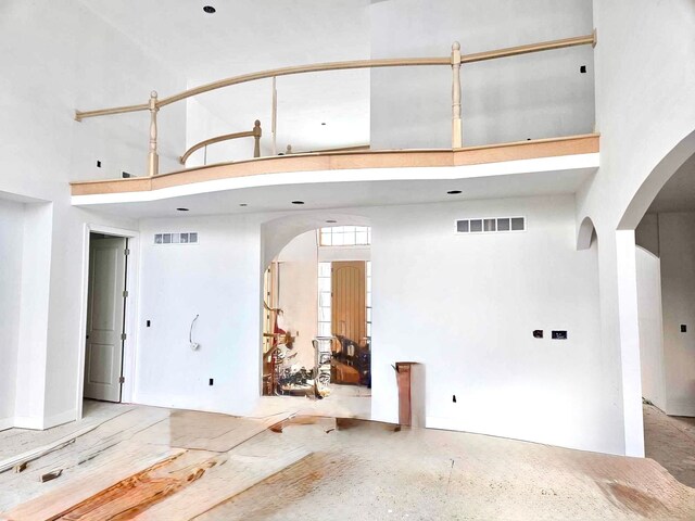 2423 Buckthorn Dr, Shelby, MI 48316 - interior space with visible vents, arched walkways, and a towering ceiling