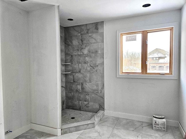2423 Buckthorn Dr, Shelby, MI 48316 - bathroom featuring a tile shower, baseboards, and marble finish floor