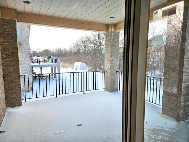 view of snow covered back of property