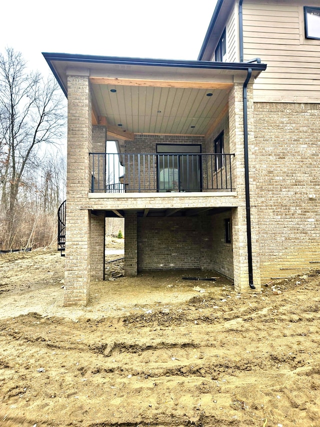 2423 Buckthorn Dr, Shelby, MI 48316 - back of house featuring brick siding and a balcony