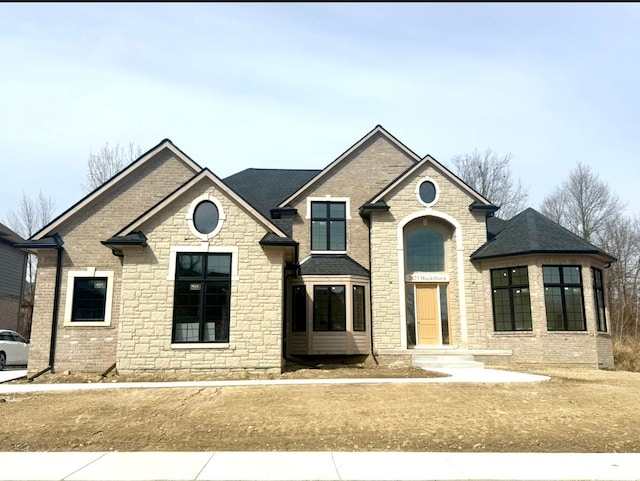 2423 Buckthorn Dr, Shelby, MI 48316 - view of front facade featuring brick siding, a shingled roof, and stone siding