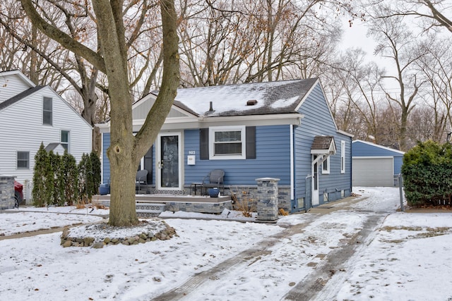 bungalow-style house featuring an outbuilding and a garage