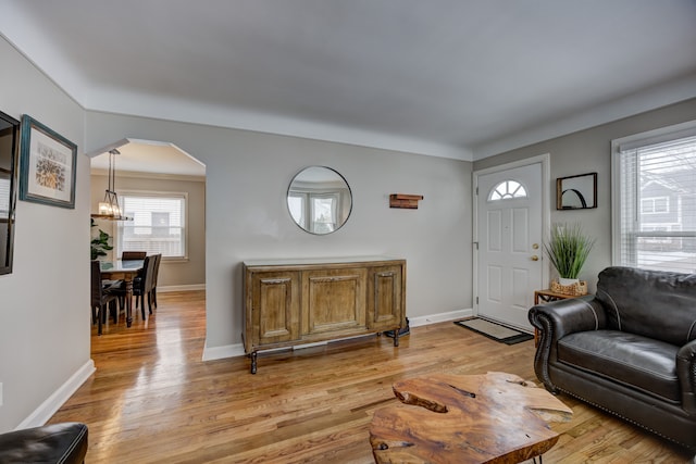 living room featuring an inviting chandelier and light wood-type flooring