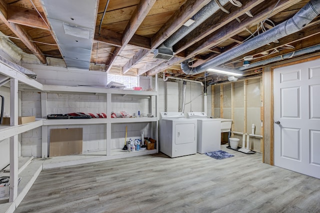 basement featuring hardwood / wood-style flooring and washing machine and dryer