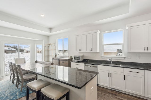 kitchen with a raised ceiling, sink, white cabinets, and dark hardwood / wood-style floors