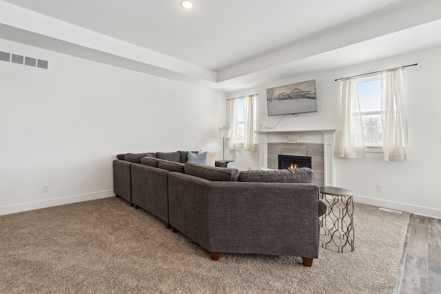 living room with hardwood / wood-style floors and a tile fireplace