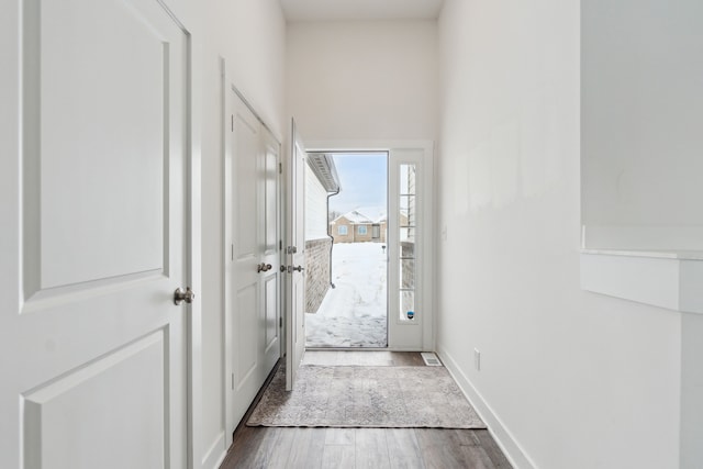 doorway with dark wood-type flooring