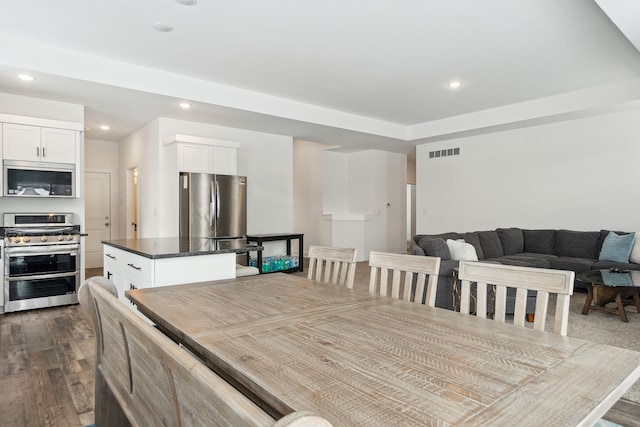 dining room with dark hardwood / wood-style flooring