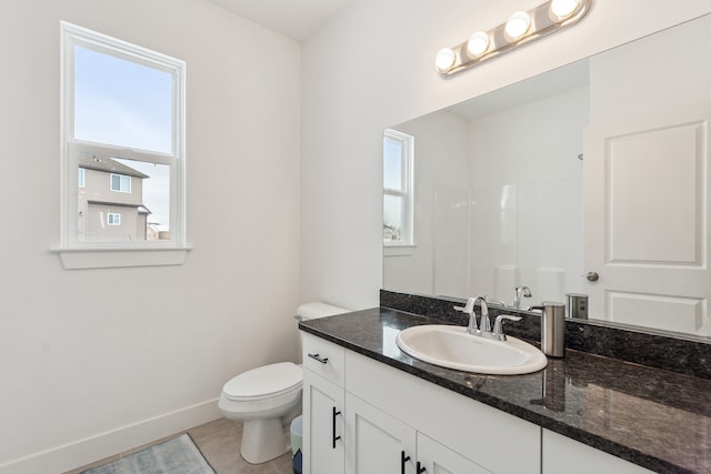 bathroom featuring tile patterned floors, vanity, and toilet