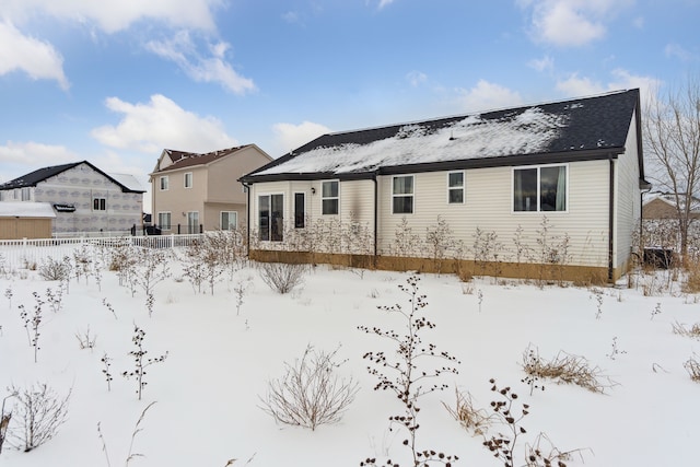 view of snow covered back of property