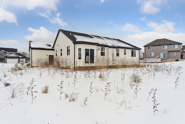 view of snow covered rear of property