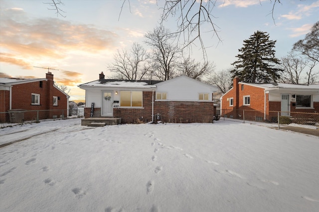 view of snow covered rear of property