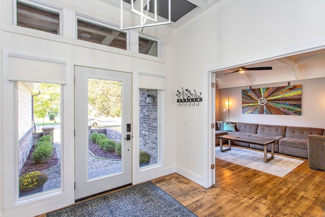 entrance foyer featuring hardwood / wood-style floors and a towering ceiling