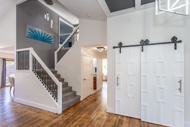 entryway featuring a barn door and dark hardwood / wood-style floors