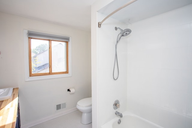 full bathroom featuring toilet, tiled shower / bath, tile patterned floors, and vanity