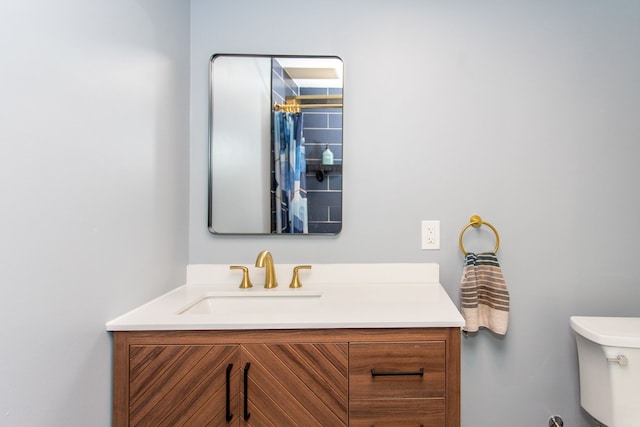 bathroom featuring toilet and vanity