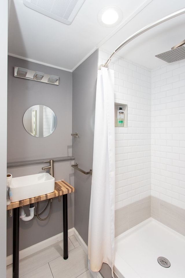 bathroom featuring sink, tile patterned floors, crown molding, and a shower with curtain