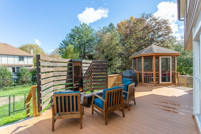 wooden deck with a grill, a sunroom, and an outdoor living space