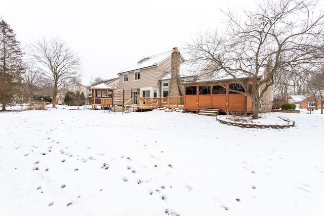 snow covered property featuring a deck