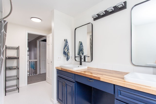 bathroom with tile patterned floors and vanity