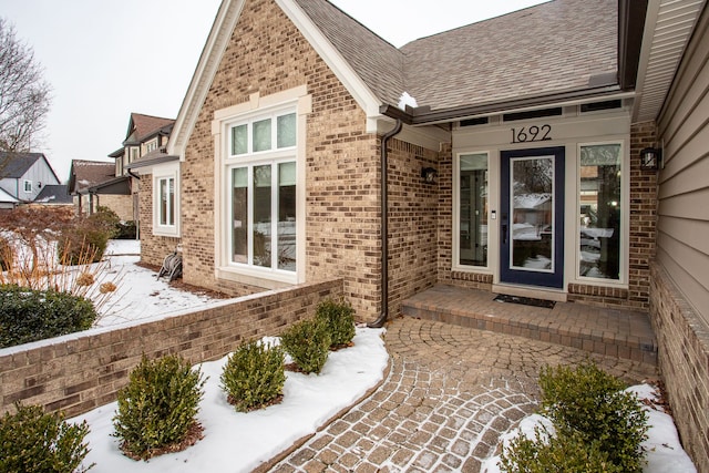 view of snow covered property entrance