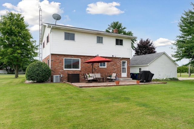 rear view of property with a patio area, cooling unit, and a lawn