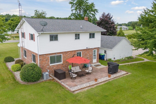 back of property featuring central air condition unit, a yard, and a patio