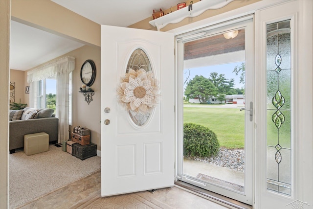 entrance foyer featuring light carpet