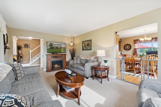 carpeted living room with a chandelier