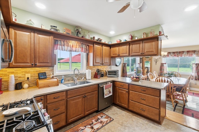 kitchen featuring sink, decorative backsplash, kitchen peninsula, and stainless steel appliances