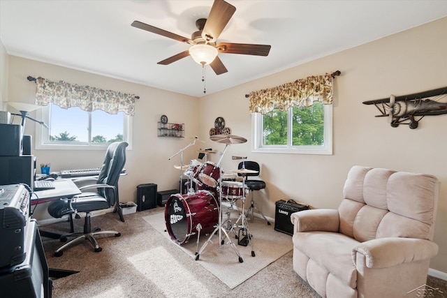 carpeted office space featuring ceiling fan