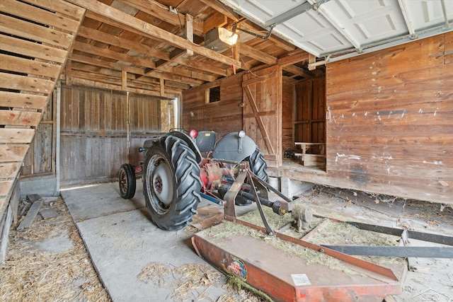 garage featuring wood walls and a garage door opener