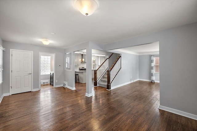 interior space featuring a wealth of natural light and dark hardwood / wood-style flooring