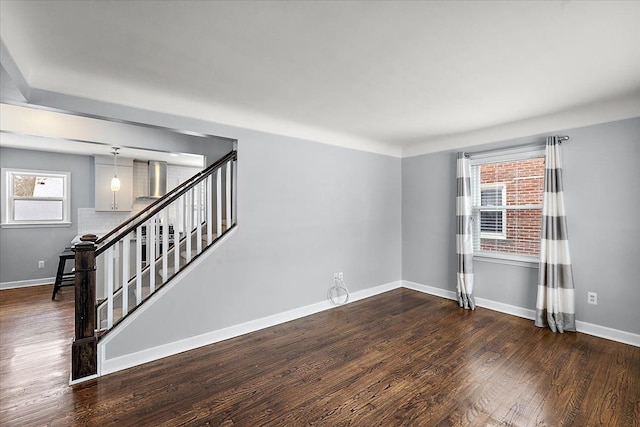 unfurnished room featuring dark hardwood / wood-style floors and plenty of natural light