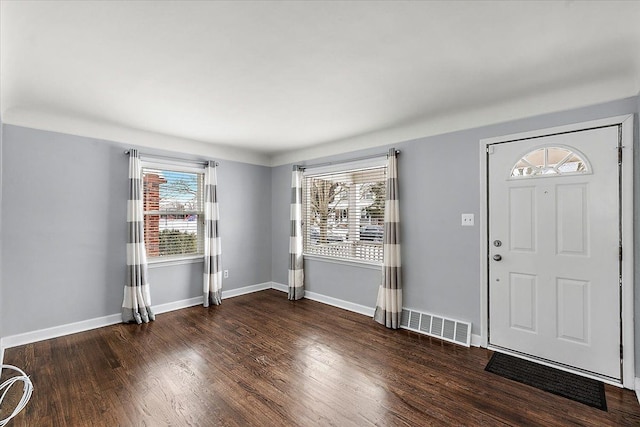 entrance foyer with a wealth of natural light and dark hardwood / wood-style flooring