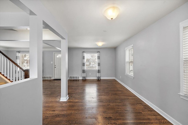 interior space featuring a wealth of natural light and dark hardwood / wood-style flooring