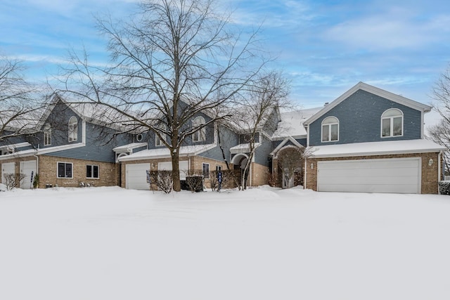 traditional home featuring brick siding and an attached garage