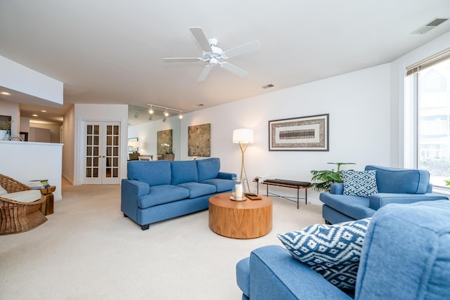 living area with french doors, carpet, rail lighting, and visible vents