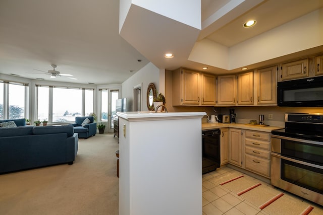 kitchen with recessed lighting, a peninsula, open floor plan, light countertops, and black appliances