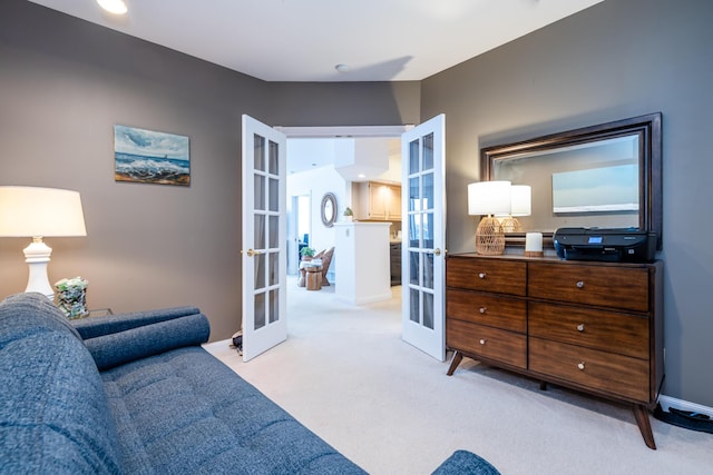 bedroom with baseboards, light colored carpet, and french doors