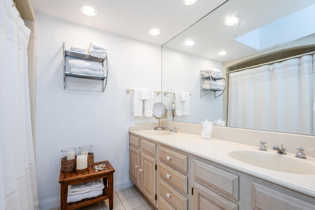 bathroom featuring recessed lighting, tile patterned floors, a sink, and double vanity